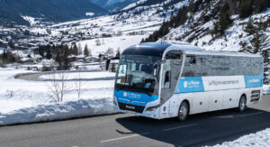 Un bus HMV roule devant un paysage hivernal